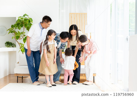 Three-generation family relaxing in the living room Three-generation family relaxing in the living room 119756960