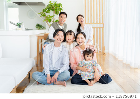 Three-generation family relaxing in the living room Three-generation family relaxing in the living room 119756971