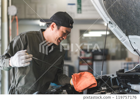 Middle-aged Asian man, mechanic, auto mechanic working at a repair shop 119757176