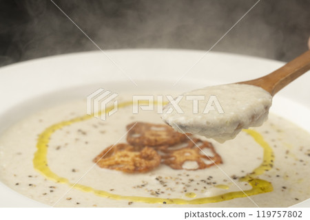 Lifting lotus root potage with a spoon Lifting lotus root potage with a spoon 119757802