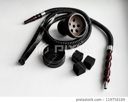 Traditional hookah set with hose, bowl, tongs, and charcoal on white background 119758189