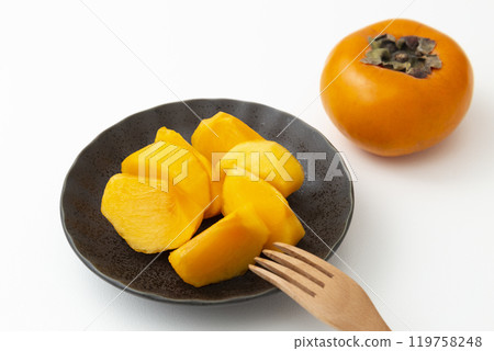 Cut persimmon on a white background 119758248