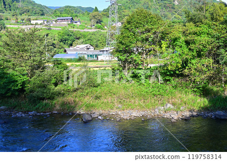 The Tone River in the early morning with the morning sun shining on it. Near Komatsu Power Plant. Scenery of houses along the river. Minakami Town. The Tone River in the early morning with the morning sun shining on it. Near Komatsu Power Plant. Scenery of houses along the river. Minakami Town. 119758314