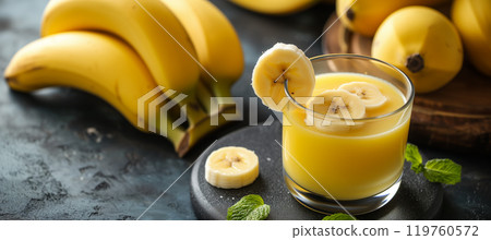 Glass of freshly squeezed banana juice with ripe bananas - copy space available 119760572