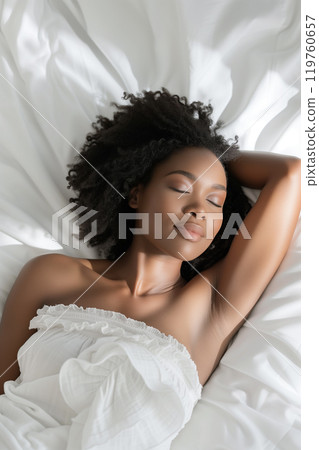 Smiling african american woman sleeping on white bed with copy space Smiling african american woman sleeping on white bed with copy space 119760657