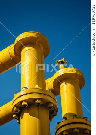 Gas distribution station with pipes and valves under clear blue sky 119760722