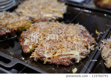 Okonomiyaki is a type of teppanyaki made with a variety of batters and toppings throughout Japan Okonomiyaki is a type of teppanyaki made with a variety of batters and toppings throughout Japan 119760791