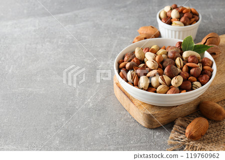 Assorted nuts in white bowls on a gray background 119760962