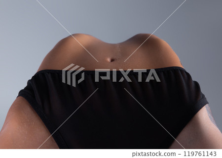 Photo of the woman belly and navel during doing a backbend 119761143