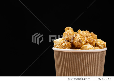 Sweet caramelized popcorn in a bucket. Place for text Sweet caramelized popcorn in a bucket. Place for text 119762238