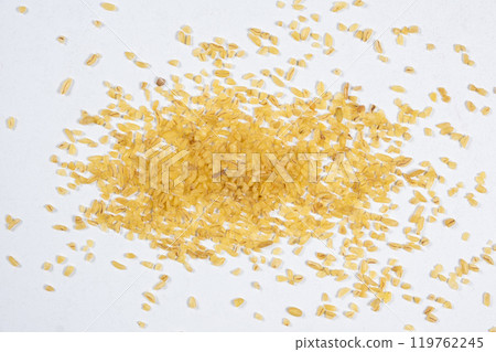 Macro scattered bulgur cracked wheat on a white background Macro scattered bulgur cracked wheat on a white background 119762245
