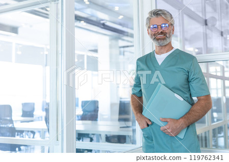Good-looking gray-haired bearded male doctor in lab coat smiling nicely 119762341