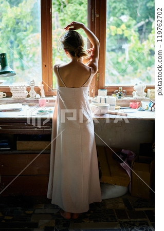 Portrait of young beautiful woman posing in craft workshop 119762702