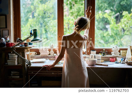 Beautiful young woman posing in craft workshop 119762703