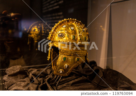 Medieval golden helmet, richly decorated with precious stones, is on display at the museum. Protective equipment of the knights 119763094