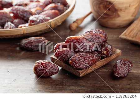 Dried dates on a old wooden table. 119763204