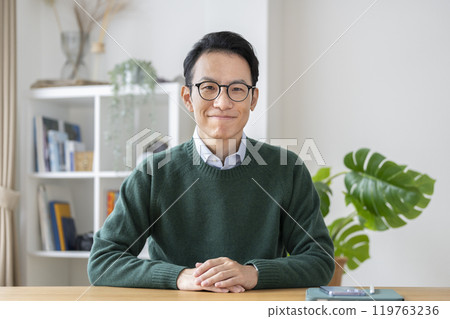 A man in his late 30s looking at the camera 119763236