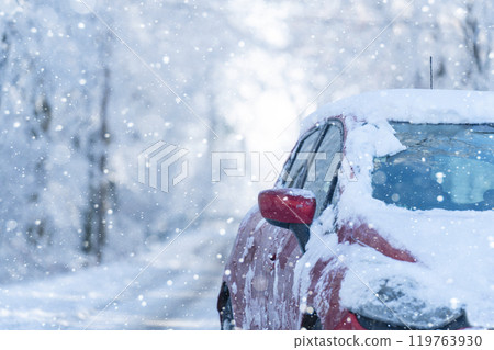 Car on a winter road through a snow covered forest 119763930