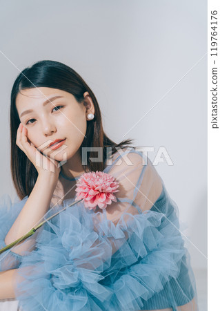 Beauty image of young woman and flowers 119764176