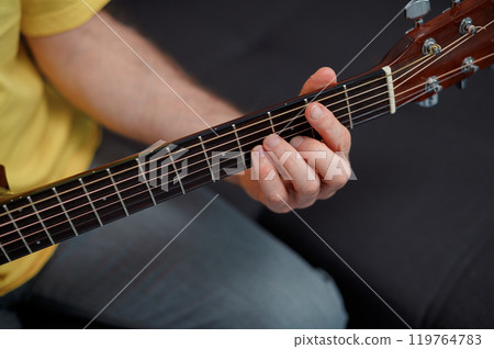 Guitarist on acoustic guitar playing melody. Close up musician instrument 119764783