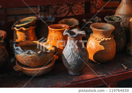 Antique Asian traditional clay pots, vases and jugs in pottery workshop in Vietnam in Asia 119764830