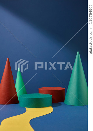 Colorful Christmas theme photography from frontal shot. Two empty cylinder platforms placed in center of yellow road, cone shape blocks decorated on both sides Colorful Christmas theme photography from frontal shot. Two empty cylinder platforms placed in center of yellow road, cone shape blocks decorated on both sides 119764903
