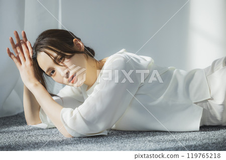 Young woman by the window 119765218