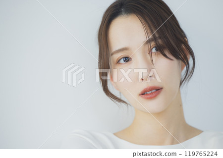 Young woman by the window Young woman by the window 119765224