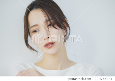 Young woman by the window 119765225