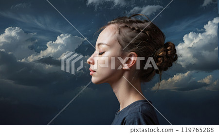 Conceptual depiction of a believing person, head turned towards heaven, radiating inner peace, calm equilibrium and hope 119765288