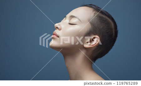 Conceptual depiction of a believing person, head turned towards heaven, radiating inner peace, calm equilibrium and hope 119765289