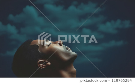 Conceptual depiction of a believing person, head turned towards heaven, radiating inner peace, calm equilibrium and hope 119765294