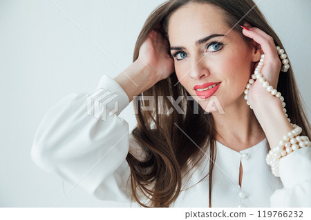 Portrait of a beautiful woman in a white summer dress smiling 119766232