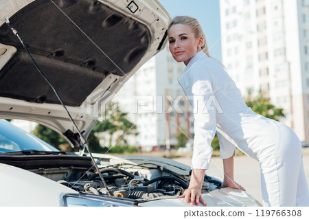 Woman Driver Mechanic Repairing Car Engine 119766308