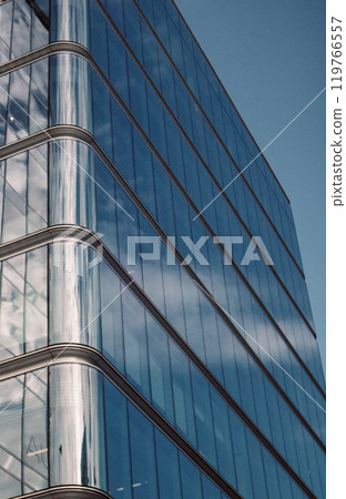 Modern office building glass facade, sky reflection in the windows of skyscraper Modern office building glass facade, sky reflection in the windows of skyscraper 119766557