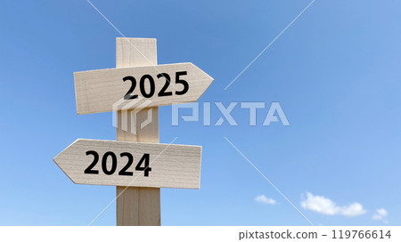 Signpost with 2025 and 2024 characters and blue sky background right space 119766614