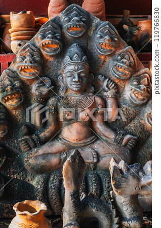 Clay Buddhist figurine statue of god Shiva in a souvenir shop in Vietnam in Asia 119766830