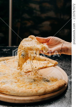 Melting cheesy pizza slice being lifted, showcasing gooey cheese pull, perfect for pizza lovers Melting cheesy pizza slice being lifted, showcasing gooey cheese pull, perfect for pizza lovers 119767072