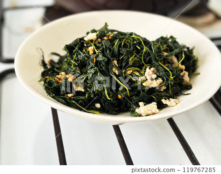 Close up Thai-Chinese food called Pad Bai Por of stir-fried Mulukhiyah leaves with ground pork. Homemade food local Thai-Chinese menu. 119767285