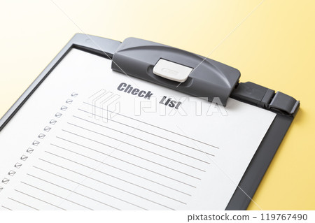 Checklist on a yellow background 119767490