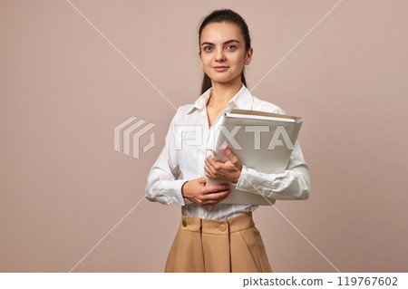 happy businesswoman holding folders. Confident woman in white shirt looking at the camera, copy space 119767602