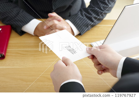 Woman submitting her resignation (no face) 119767927