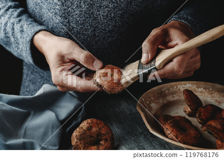 man uses a brush to clean some rovellons 119768176
