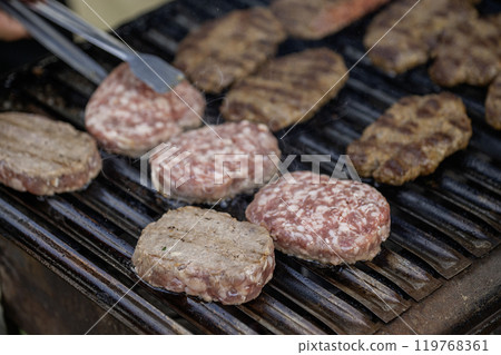 Meat is being grilled on a barbecue Meat is being grilled on a barbecue 119768361