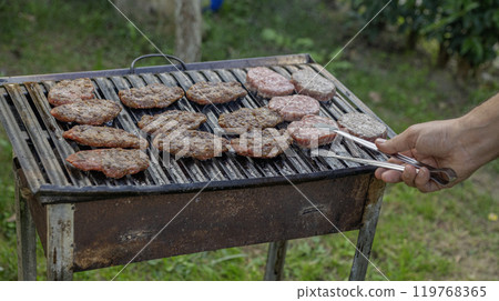 Meat is being grilled on a barbecue 119768365