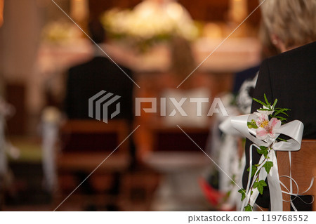 An Elegant and Beautiful Wedding Ceremony Taking Place in a Charming Church Setting 119768552