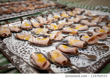 Elegant and visually appealing appetizers expertly served on beautifully decorative spoons 119768555
