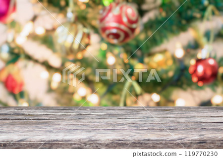 Empty wood table top with blur Christmas tree with bokeh light background Empty wood table top with blur Christmas tree with bokeh light background 119770230