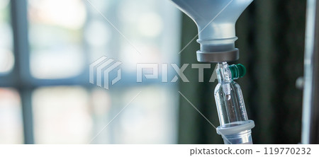 Close up medical intravenous IV drip in hospital background 119770232