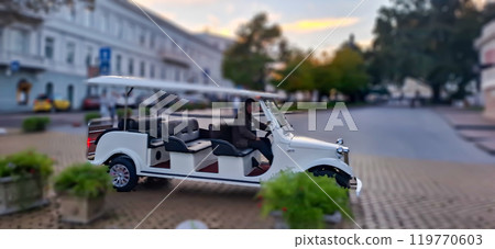 Sightseeing car. Motion effect with blurred background. In Odessa, a tour car drives along Pushkinskaya Street. Blurred photo with bokeh background. 119770603